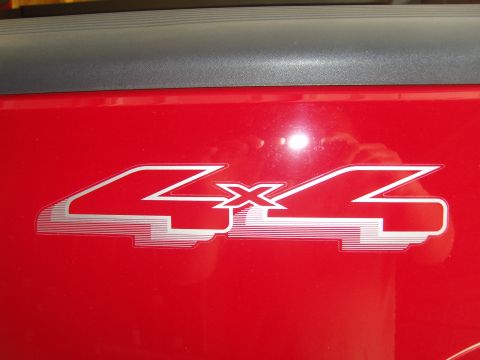 2007 Ford Mustang - Close-up of a red vehicle's 4x4 decal.