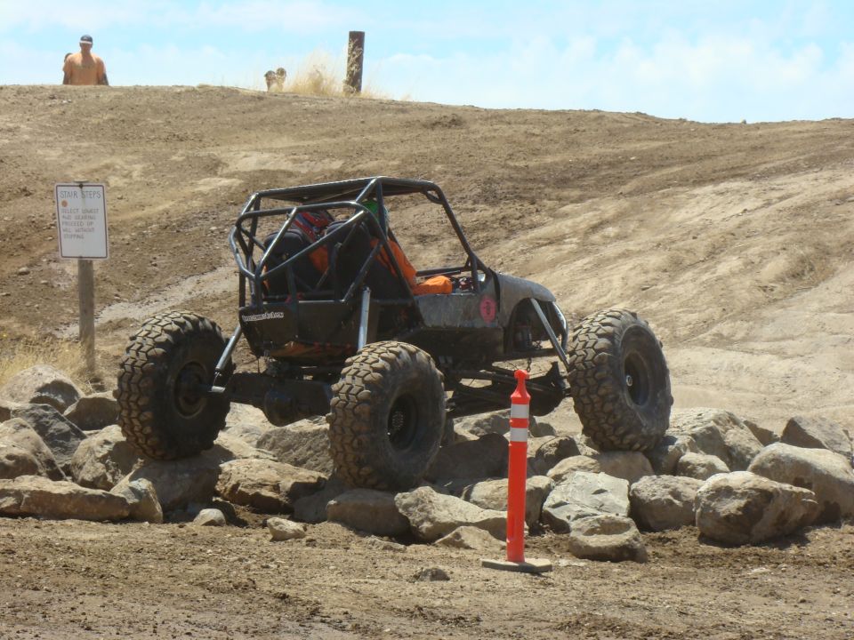 Off-road buggy with large tires navigating rocks