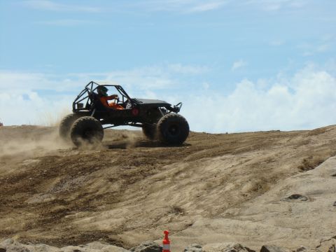 1989 Ford Bronco - A custom off-road buggy navigates a dusty terrain during a race event.