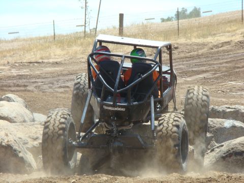1989 Ford Bronco - A custom-built buggy with a roll cage navigates a challenging off-road course.