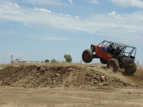 1989 Ford Bronco - This custom buggy is mid-air after launching off a dirt ramp.