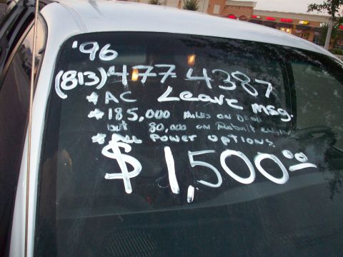 1985 Ford Bronco - Vehicle for sale with handwritten details on the windshield, priced at $1,500.
