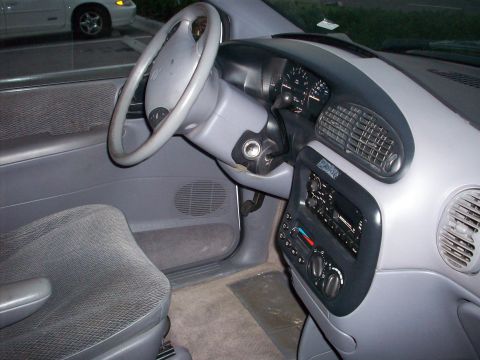 1985 Ford Bronco - The interior of a minivan is shown, focusing on the dashboard and driver's seat.