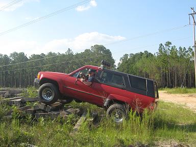 1987 Toyota 4Runner - This red 1987 Toyota 4Runner navigates a challenging off-road course, demonstrating its 4x4 capabilities.