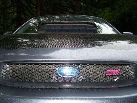 1998 Subaru Legacy - Front view of a 1998 Subaru Legacy, showing the grille and hood scoop.