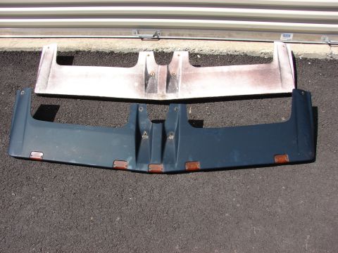 1984 Ford F-250 - Two truck sun visors are displayed on an asphalt surface in front of a building.
