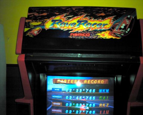 1990 Ford Taurus - An arcade game cabinet with a 'Rave Racer' logo and a screen displaying high scores.