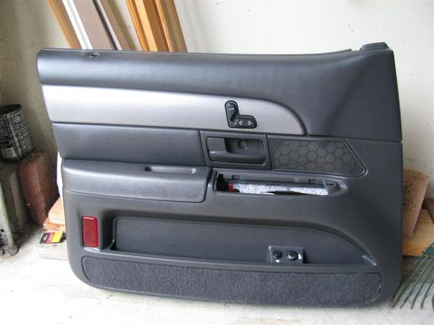 2003 Mercury Marauder - A car door panel is shown, window controls and a textured speaker grille.
