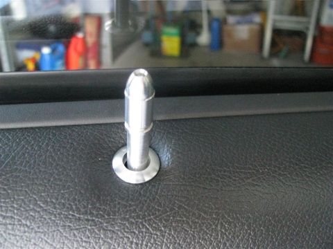 2003 Mercury Marauder - A silver door lock pin is shown on a black interior door panel, with a watermark for Supermotors.net visible.