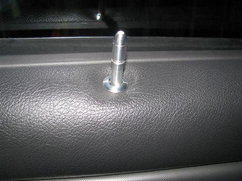 2003 Mercury Marauder - Close-up of a silver door lock pin against a textured gray interior panel.