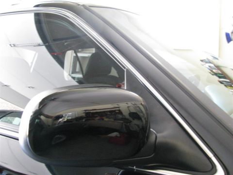 2003 Mercury Marauder - A close-up view of a car's side mirror and window trim, with reflections in the glass.