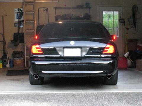 2003 Mercury Marauder - The rear of a black 2003 Mercury Marauder is visible in a garage, with its taillights illuminated.