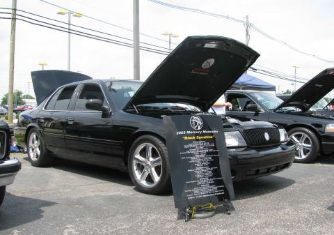 2003 Mercury Marauder - A black 2003 Mercury Marauder is displayed with its hood open at a car show, alongside another similar vehicle.