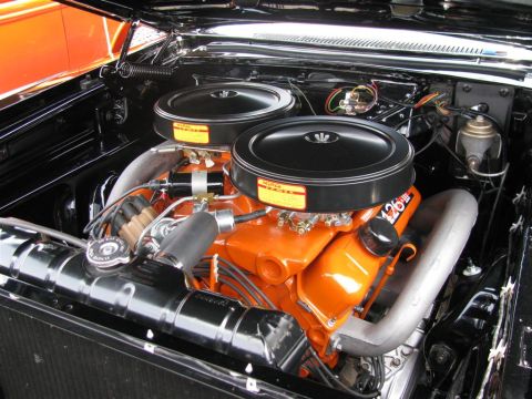 2003 Mercury Marauder - Engine bay view of a V8 engine with orange block and dual black air cleaners.