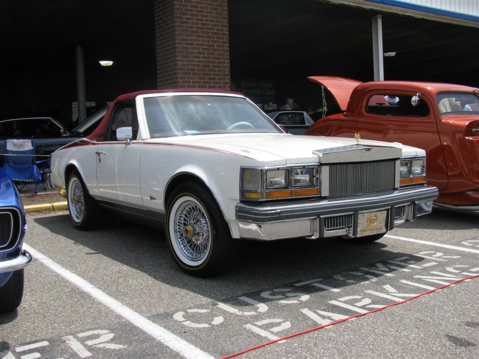 White convertible with maroon roof and wire wheels