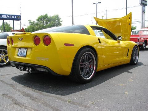2003 Mercury Marauder - Rear view of a yellow Chevrolet Corvette, showing its quad exhaust pipes and taillights.