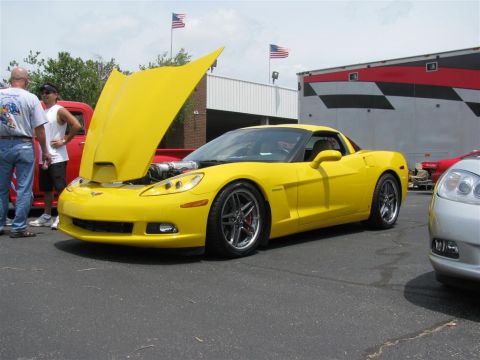 2003 Mercury Marauder - A bright yellow Chevrolet Corvette is displayed with its hood open, revealing the engine compartment.