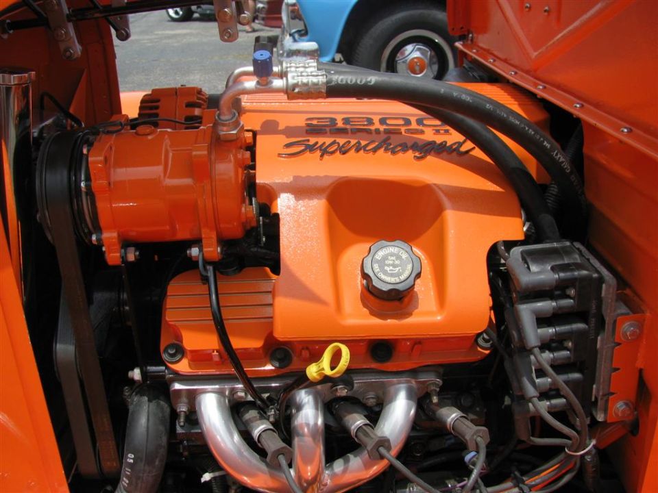 Orange-painted GM 3800 Series II Supercharged engine in a vehicle