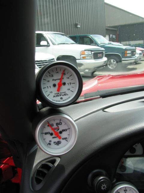 2003 Mercury Marauder - Interior view of dashboard gauges with multiple trucks parked outside.