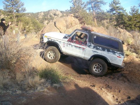 1978 Ford Bronco - This 1978 Ford Bronco is navigating a challenging off-road course with steep inclines and loose terrain.