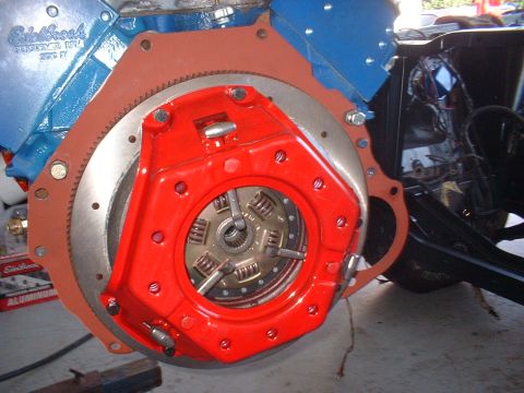1970 Ford Torino - Close-up of a red clutch assembly installed on a blue engine block, with visible Edelbrock branding.