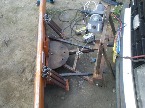 1987 Suzuki Samurai - A plow attachment is mounted to the front of a vehicle, with tools and a winch visible.