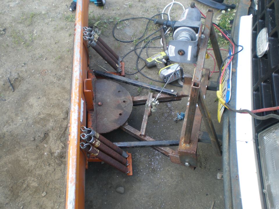Front view of plow attachment on vehicle bumper
