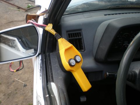 1987 Suzuki Samurai - Interior view of a vehicle showing a yellow device with buttons and exposed wiring.