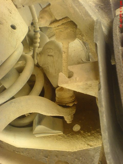 1992 Ford Crown Victoria - Undercarriage view of suspension components and a coil spring, likely from a vehicle.