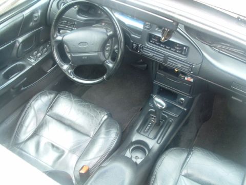1993 Ford Taurus - The interior of a 1993 Ford Taurus shows black leather seats and a full dashboard view.