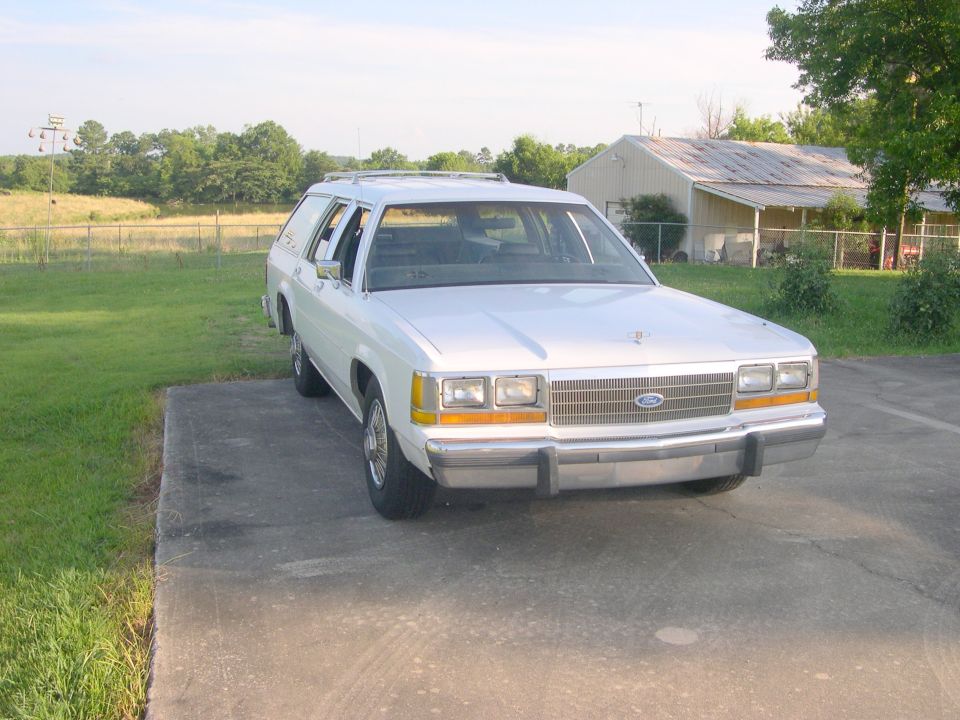 White Ford station wagon parked on a rural driveway