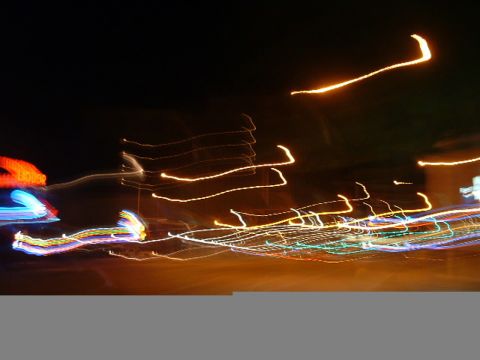 1993 Ford Taurus - Abstract streaks of light at night, possibly from moving vehicles, with a website URL visible at the bottom.