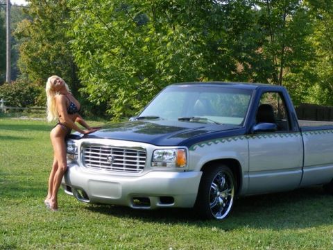 1991 Ford Crown Victoria - Woman poses with a two-tone pickup truck chrome wheels and custom body trim.