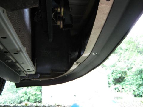2000 Mercury Grand Marquis - Close-up of the underside of a vehicle's front end, showing bumper and radiator components.