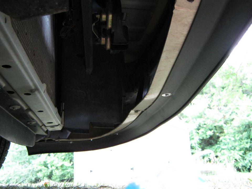 Underside view of a car's front bumper and radiator support structure