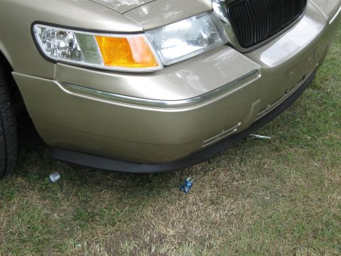 2000 Mercury Grand Marquis - The front of a gold 2000 Mercury Grand Marquis is shown, with a black lower lip and chrome accents.