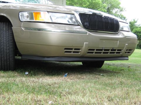 2000 Mercury Grand Marquis - Front view of a gold 2000 Mercury Grand Marquis showing its distinctive grille and bumper.