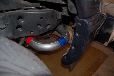 1985 Mercury Grand Marquis - Close-up view of a modified exhaust pipe on a vehicle's undercarriage.