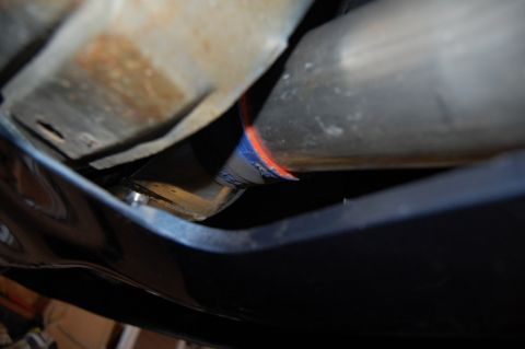 1985 Mercury Grand Marquis - Exhaust pipe connection with visible blue and orange banding.