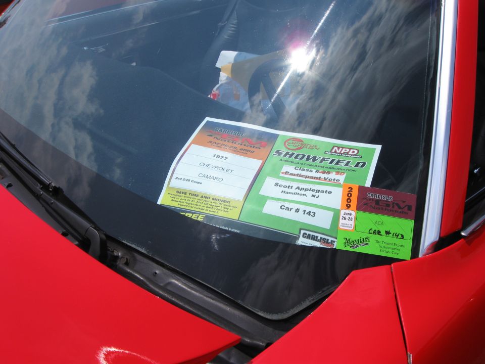 Car show entry placard for a 1977 Chevrolet Camaro under a windshield