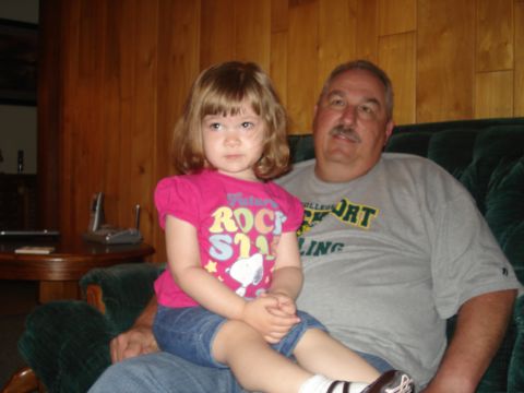 2000 Ford Crown Victoria - Man and young girl sitting together on a couch indoors.