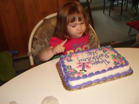 2000 Ford Crown Victoria - A child looks at a birthday cake with 'Happy Birthday Ms. ' written on it.