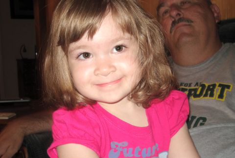 2000 Ford Crown Victoria - A young child smiles while sitting next to a man with a mustache.