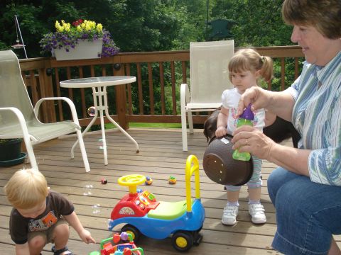 2000 Ford Crown Victoria - A family enjoys a sunny day on the deck with toys and bubbles.