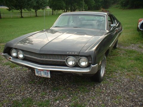 1970 Ford Falcon - Front view of a 1970 Ford Torino, showing its unique grille and dual headlights. The year is visible on the windshield.