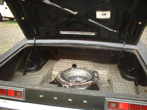 1970 Ford Falcon - The trunk of a 1970 Ford Falcon, complete with spare tire and original-style plaid lining.