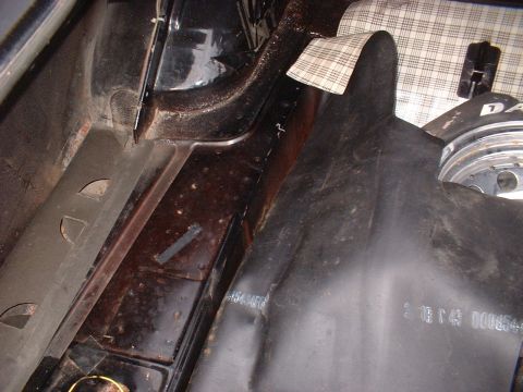 1970 Ford Falcon - This photo shows the trunk area of a vehicle, including the spare tire and surrounding structural components.