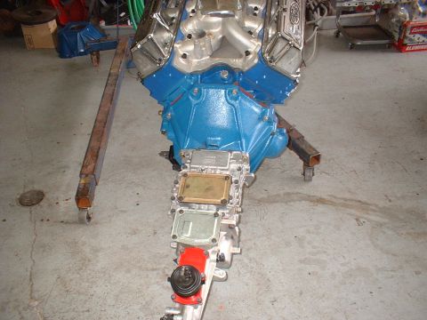 1970 Ford Torino - Engine and transmission assembly displayed on a stand in a garage setting.