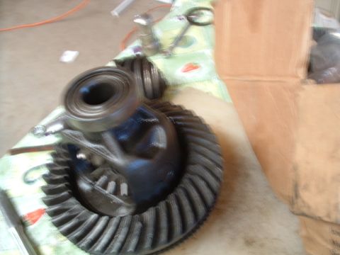 1988 Ford F-150 - A differential gear set and bearing are visible on a cloth surface, with a cardboard box in the background.