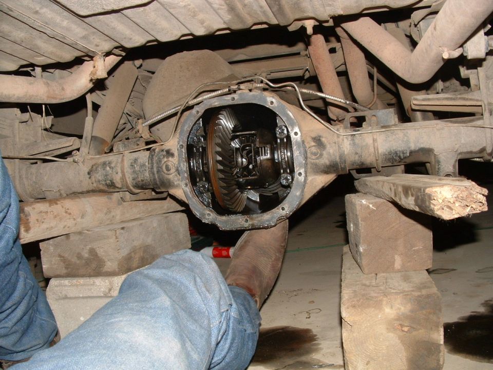 Differential housing with gears visible, supported by wooden blocks
